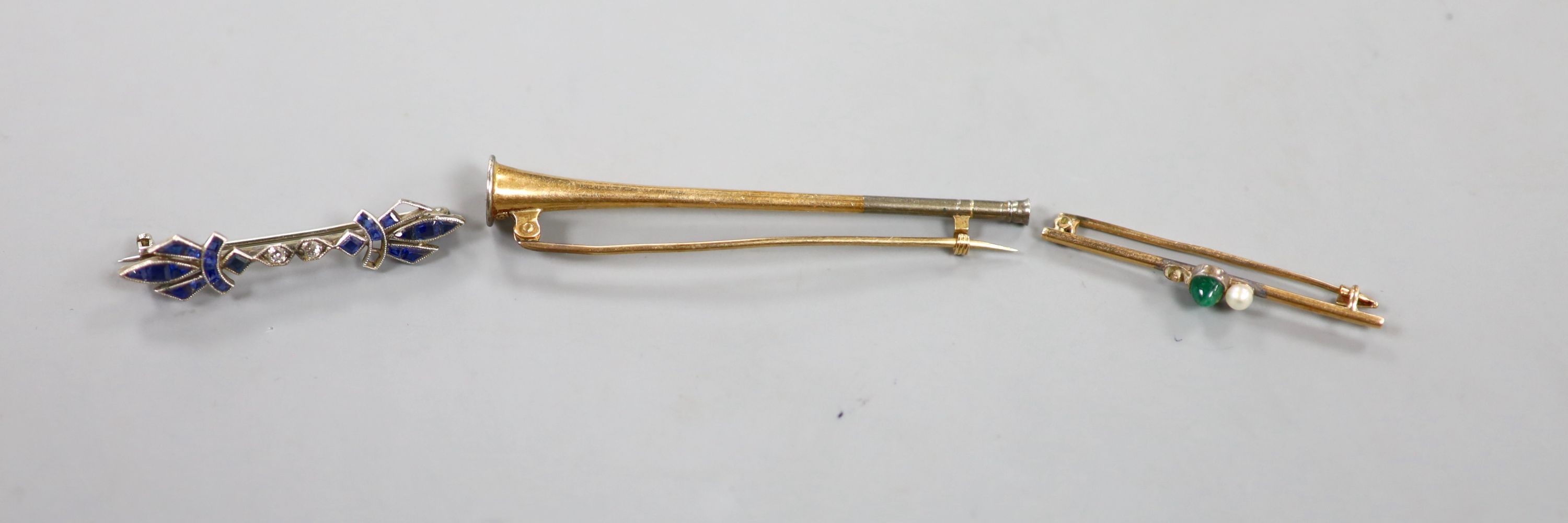 A 1920's white metal synthetic sapphire and diamond set bar brooch(stones missing), 37mm and two other bar brooches including horn and emerald and pearl(stone missing), gross weight 6.8 grams.